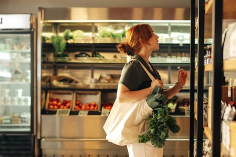 a woman browsing shelves in a grocery store